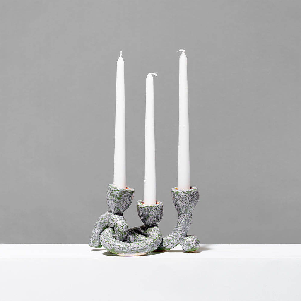 Hand built ceramic with glaze green/purple textured triple taper and three white candle sticks. Measures 7.25" x 5"
