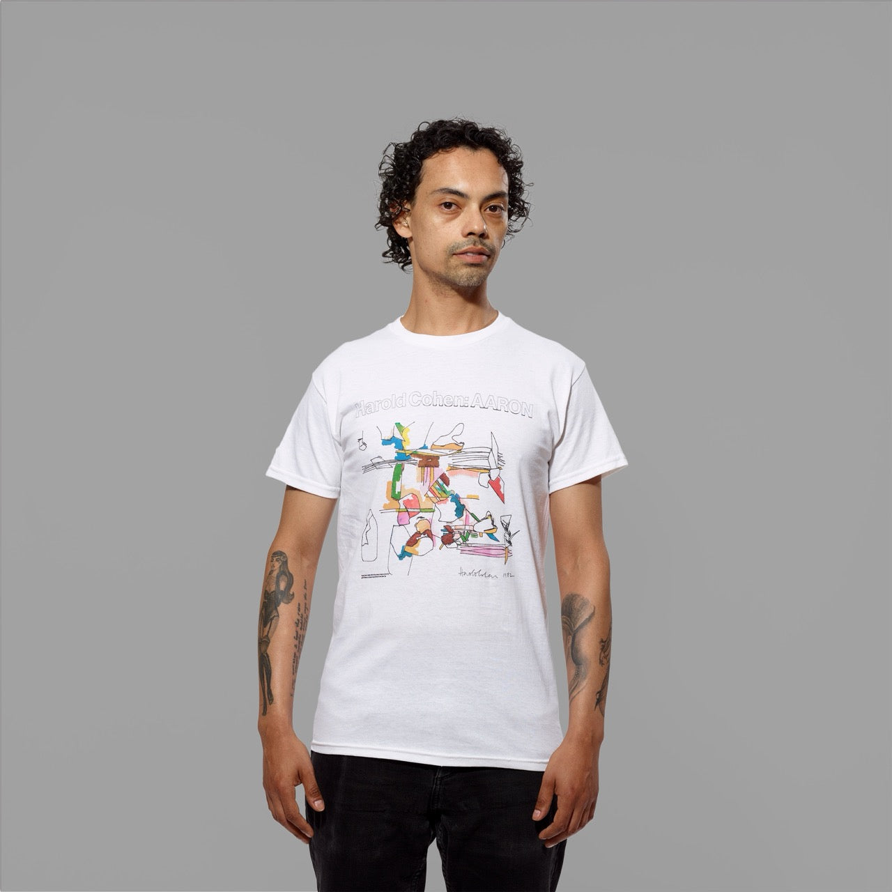 Model wearing 100% cotton white t-shirt featuring an artwork by Harold Cohen