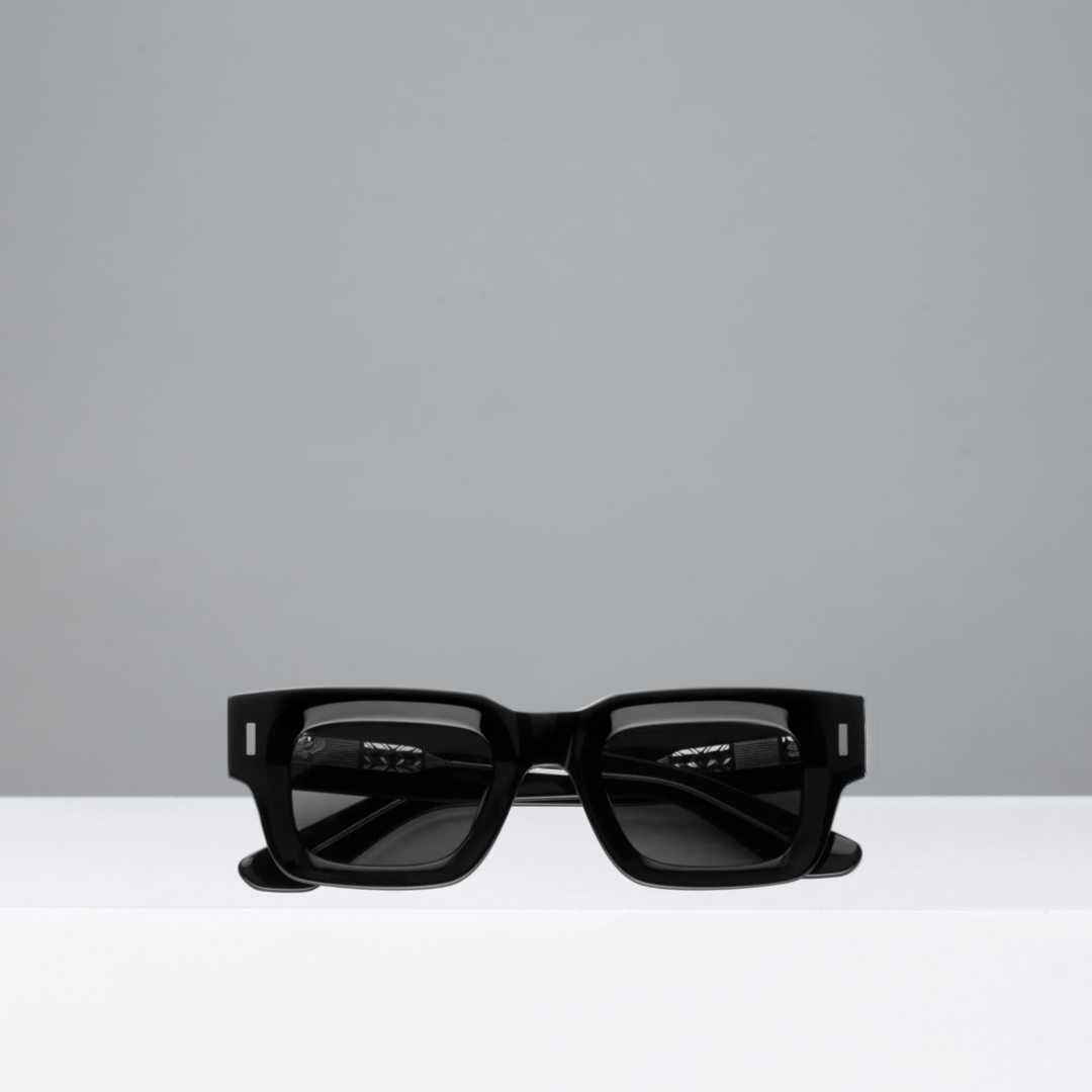 Black sunglasses on a gray background