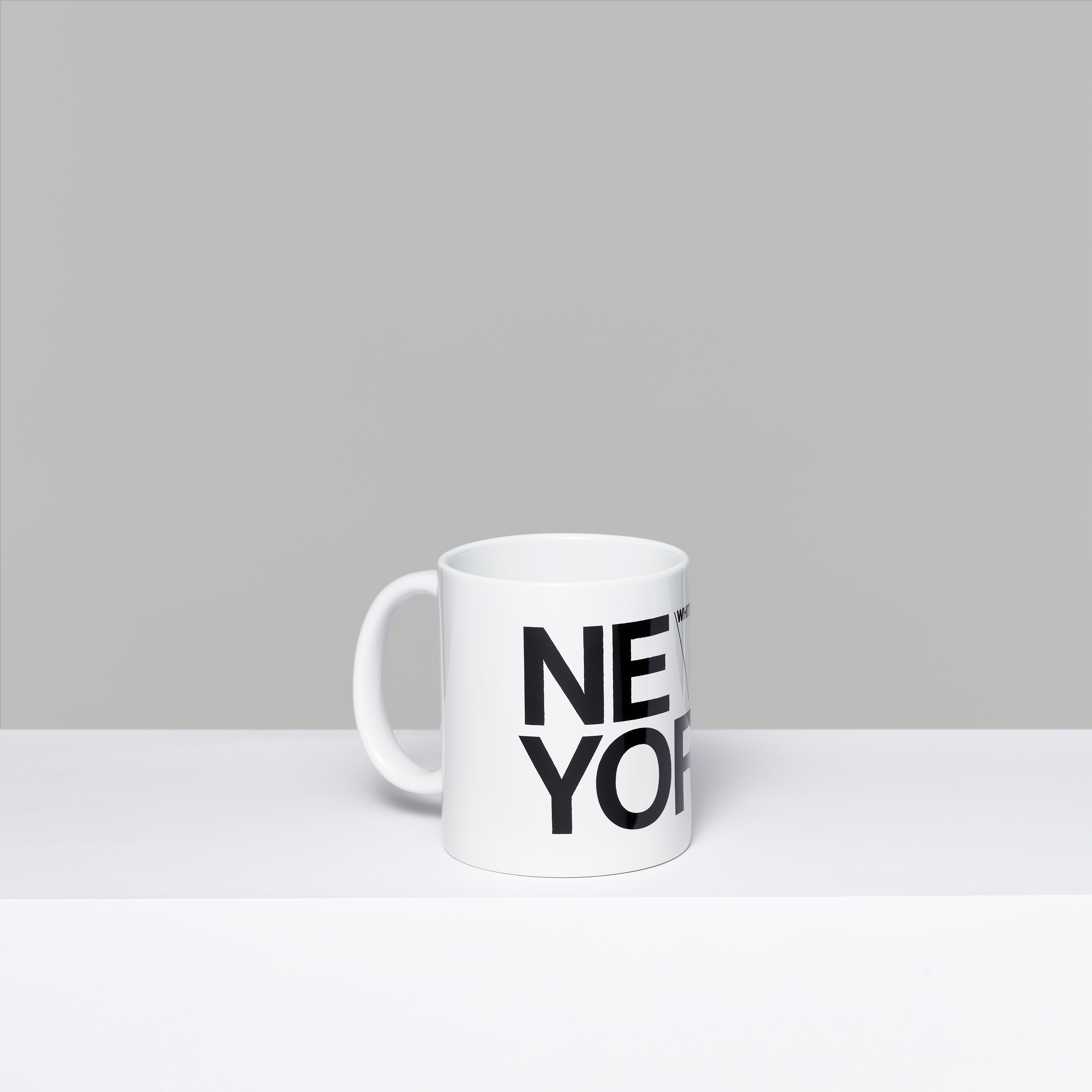 Whitney New York white ceramic mug with New York and the Whitney logo in black text. Measures 3.75" x 3"