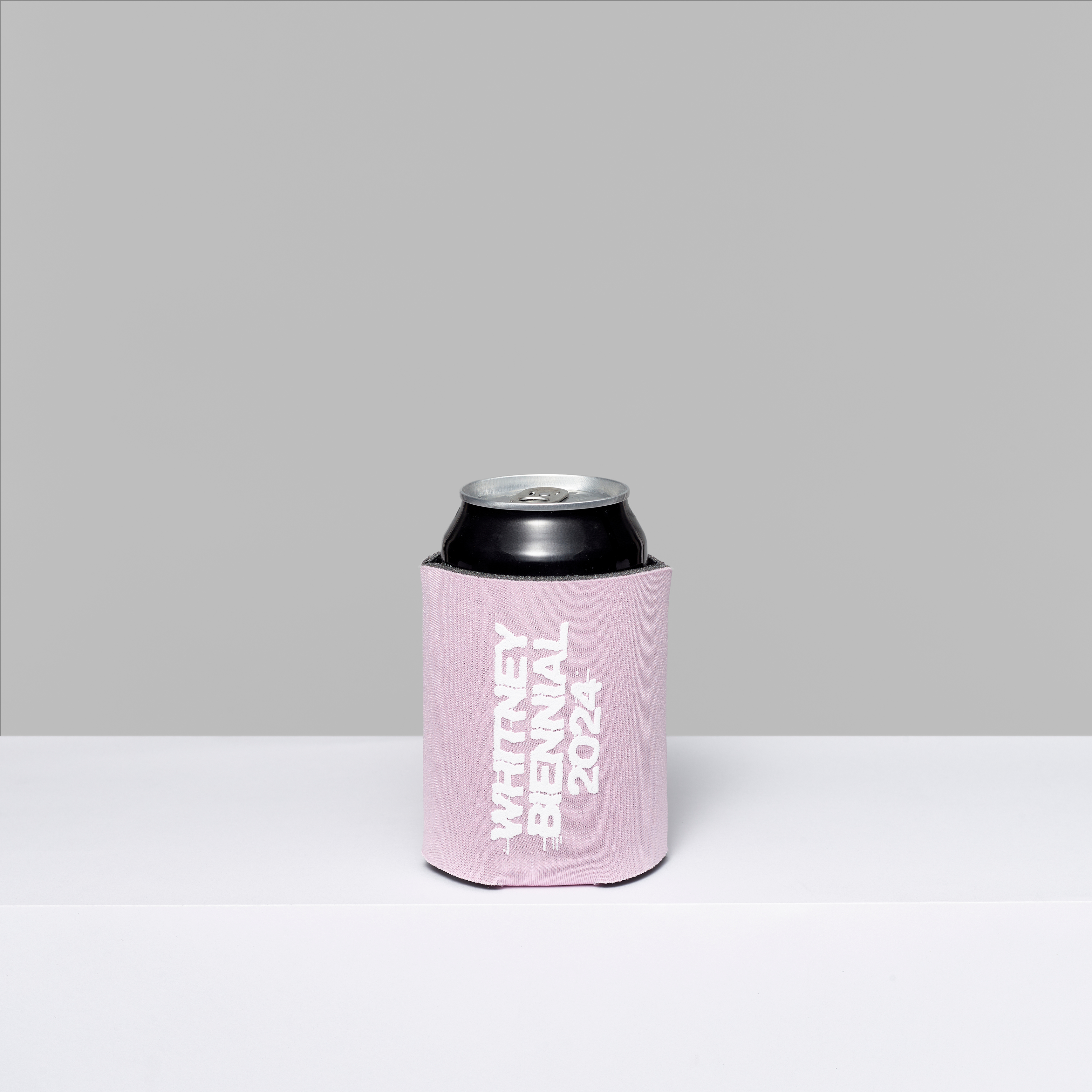 Biennial foam coozie with Whitney Biennial 2024 in white text