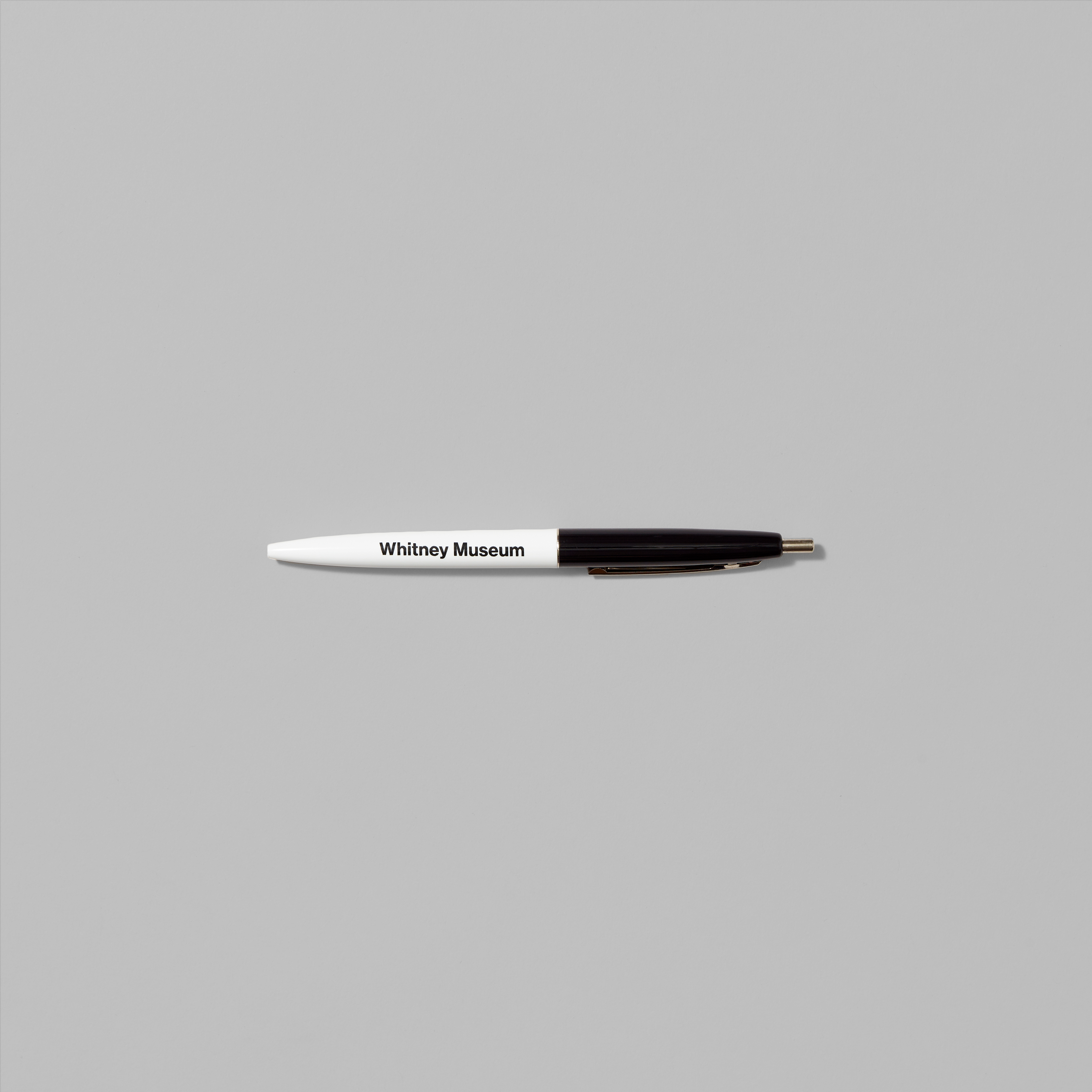 White and black Whitney classic pen with Whitney Museum in black text