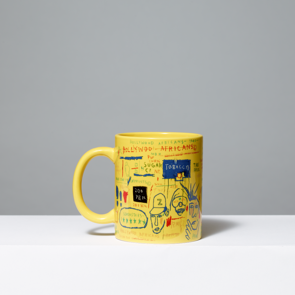 Yellow mug featuring Basquiat's Hollywood Africans on gray background