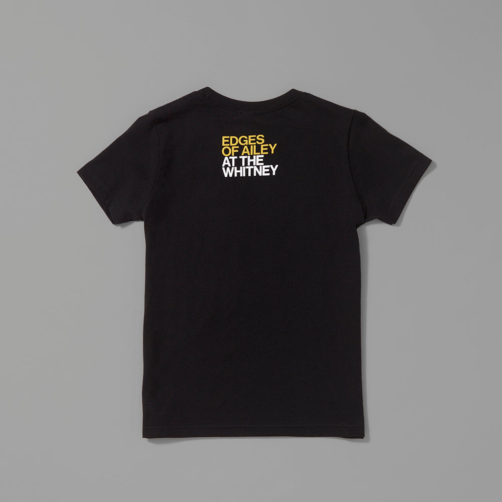 Back of the 100% cotton black kids t-shirt with Edges of Ailey in yellow text and At The Whitney in white text