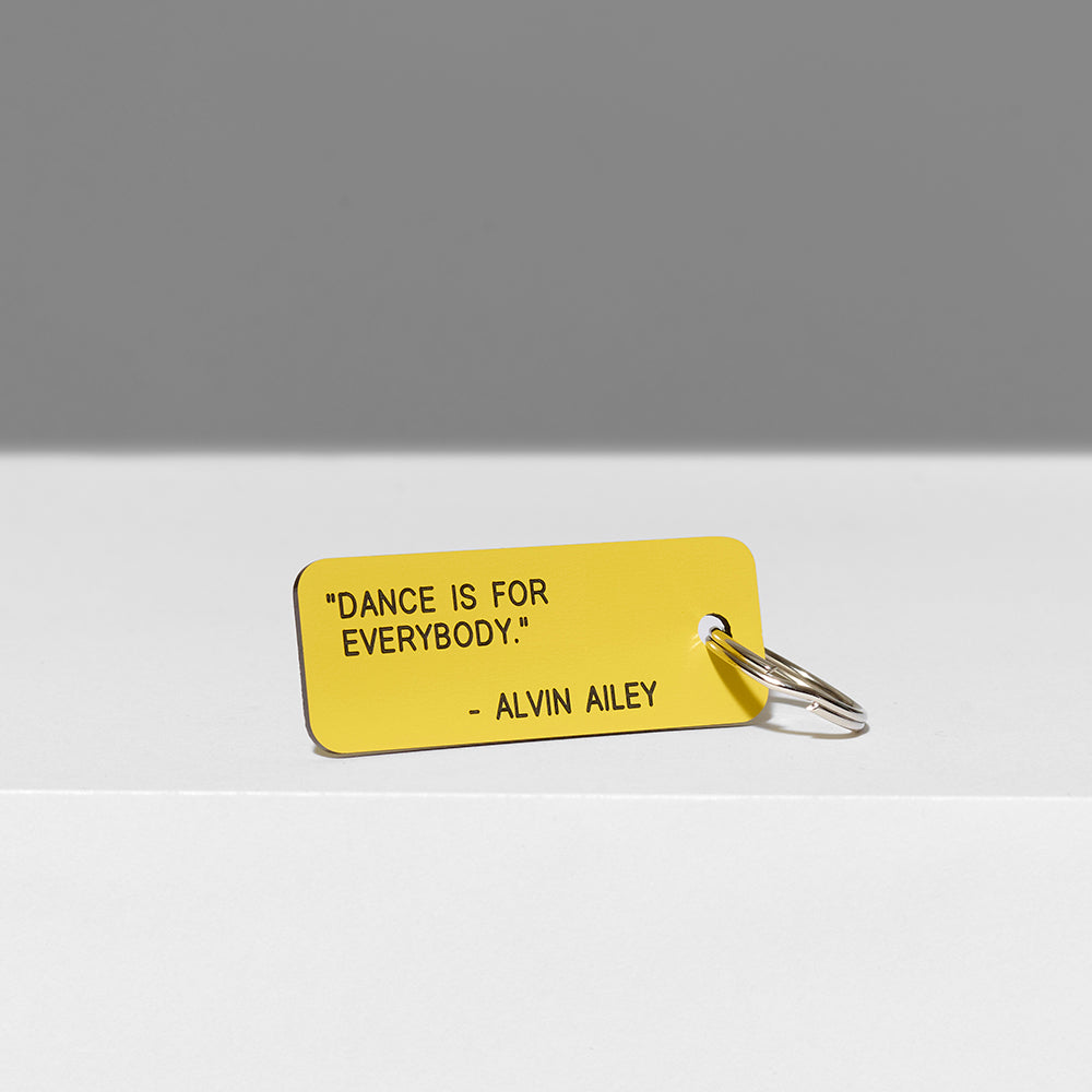 100% acrylic yellow keychain with "Dance is for everybody" quote by Alvin Ailey