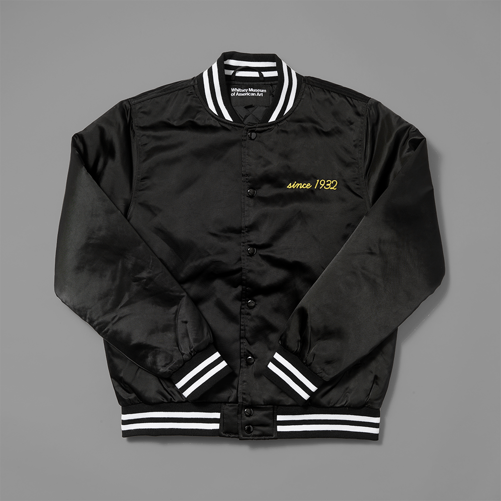 100% polyester black stadium jacket with since 1932 stitched in yellow on the   upper left chest