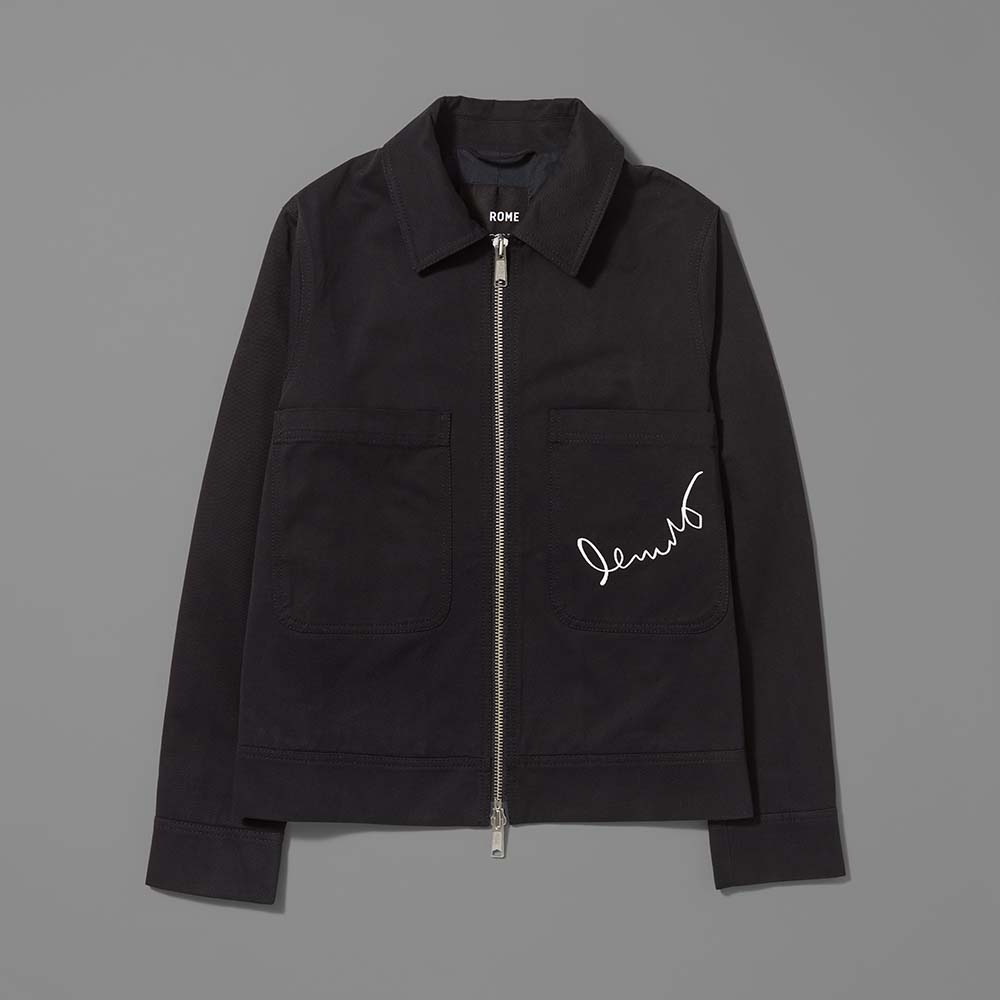 Front of the 100% cotton twill black jacket featuring Basquiat's signature on the left pocket in white embroidery