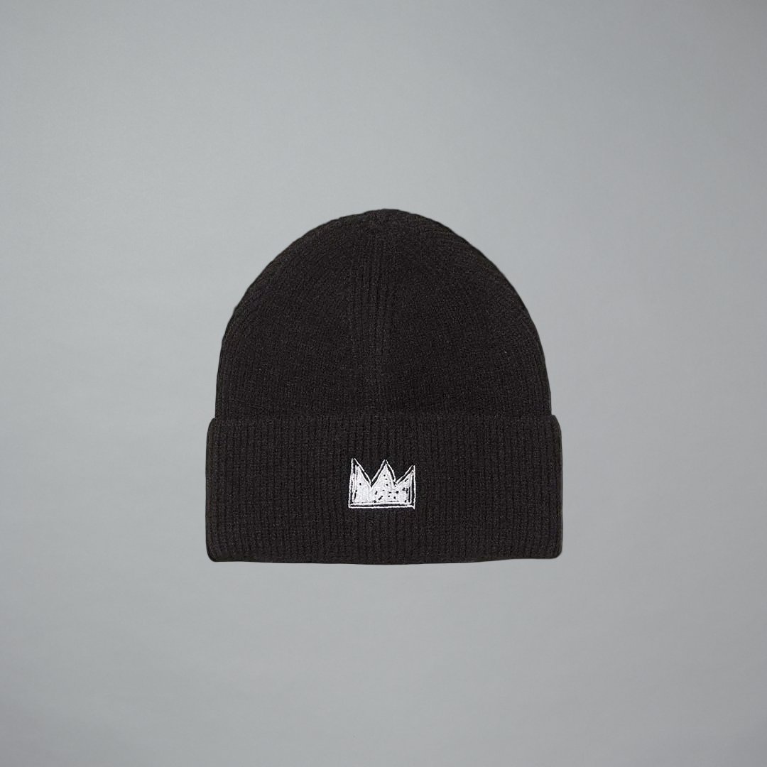 A black ribbed knit beanie hat featuring a small white embroidered crown logo on the front cuff, set against a solid gray background.