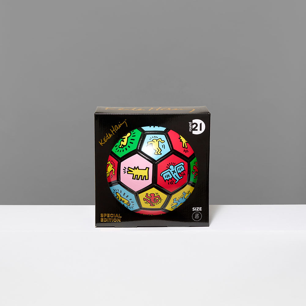 Standard thermoplastic polyurethane soccer ball as canvas featuring symbols and works by Keith Haring in its box packaging