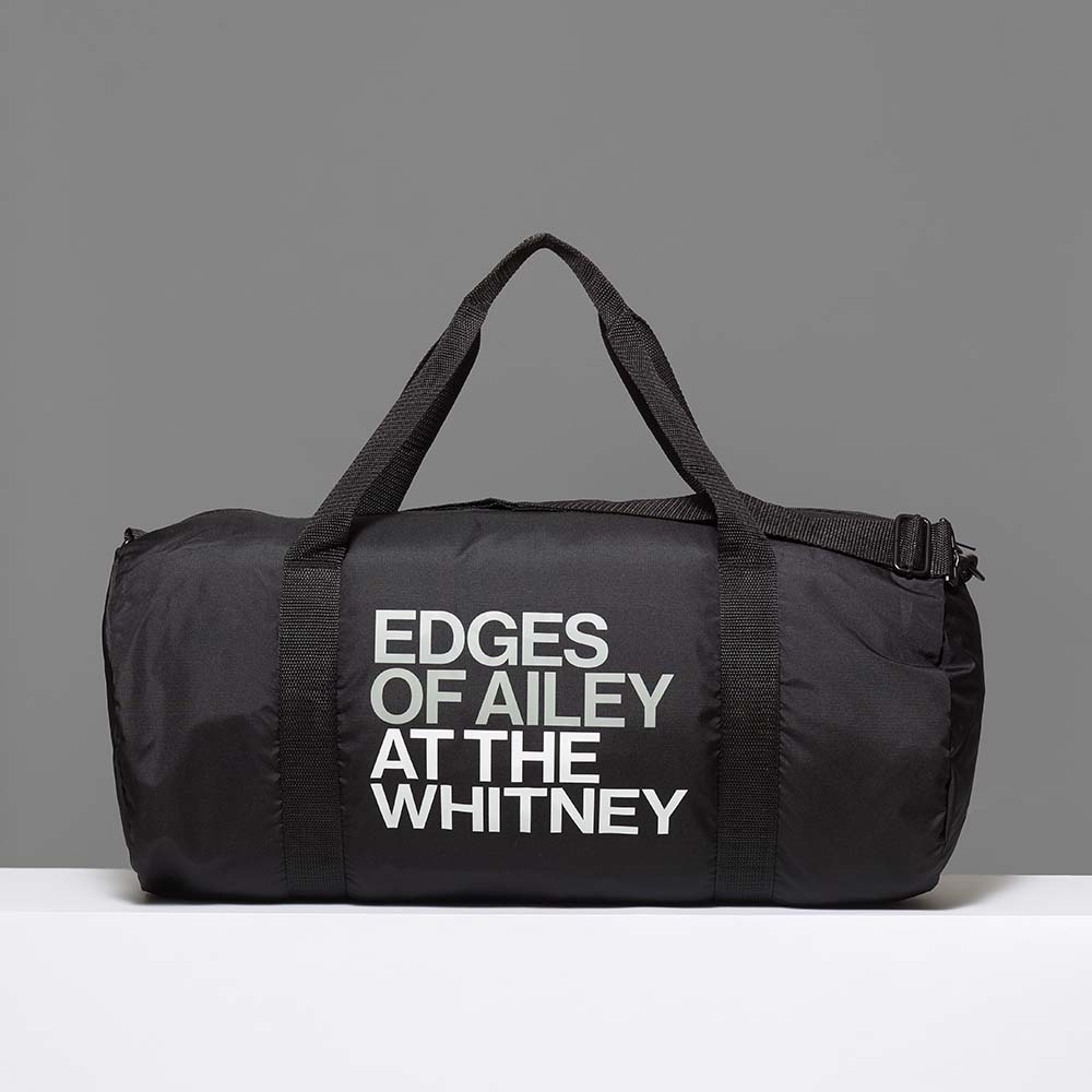 100% recycled polyester black duffle bag featuring Edges of Ailey in grey and At the Whitney in white. Measures 20" x 14".