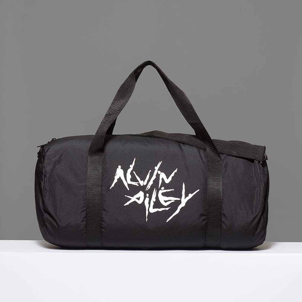 100% recycled polyester black duffle bag featuring Alvin Ailey dancers in white. Measures 20" x 14".