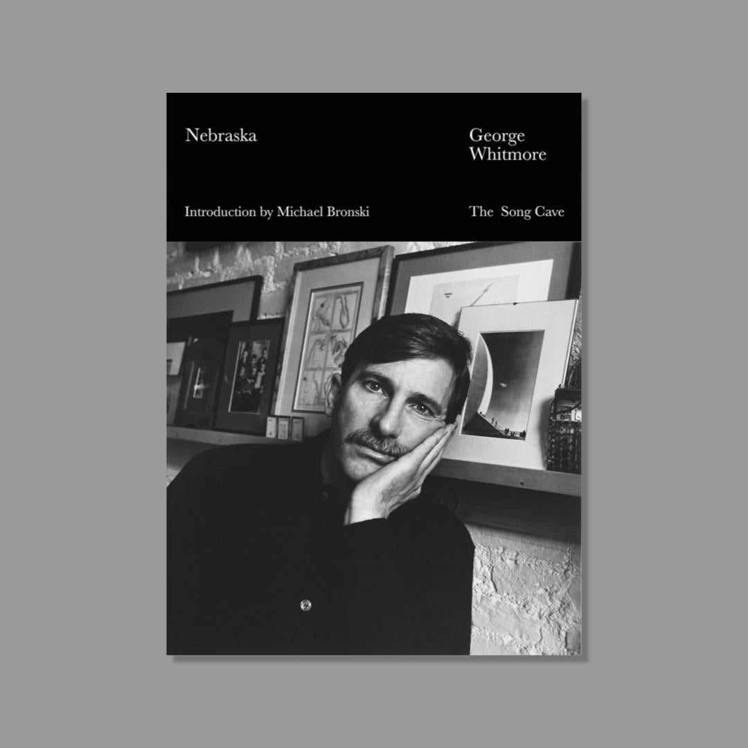 Book cover with black and white photo of George Whitmore and 'Nebraska' title in white text