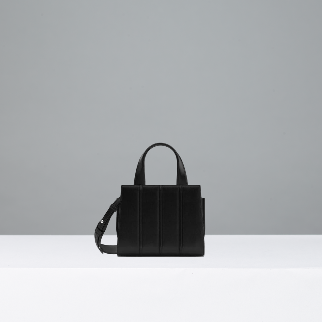 Black handbag on a gray background