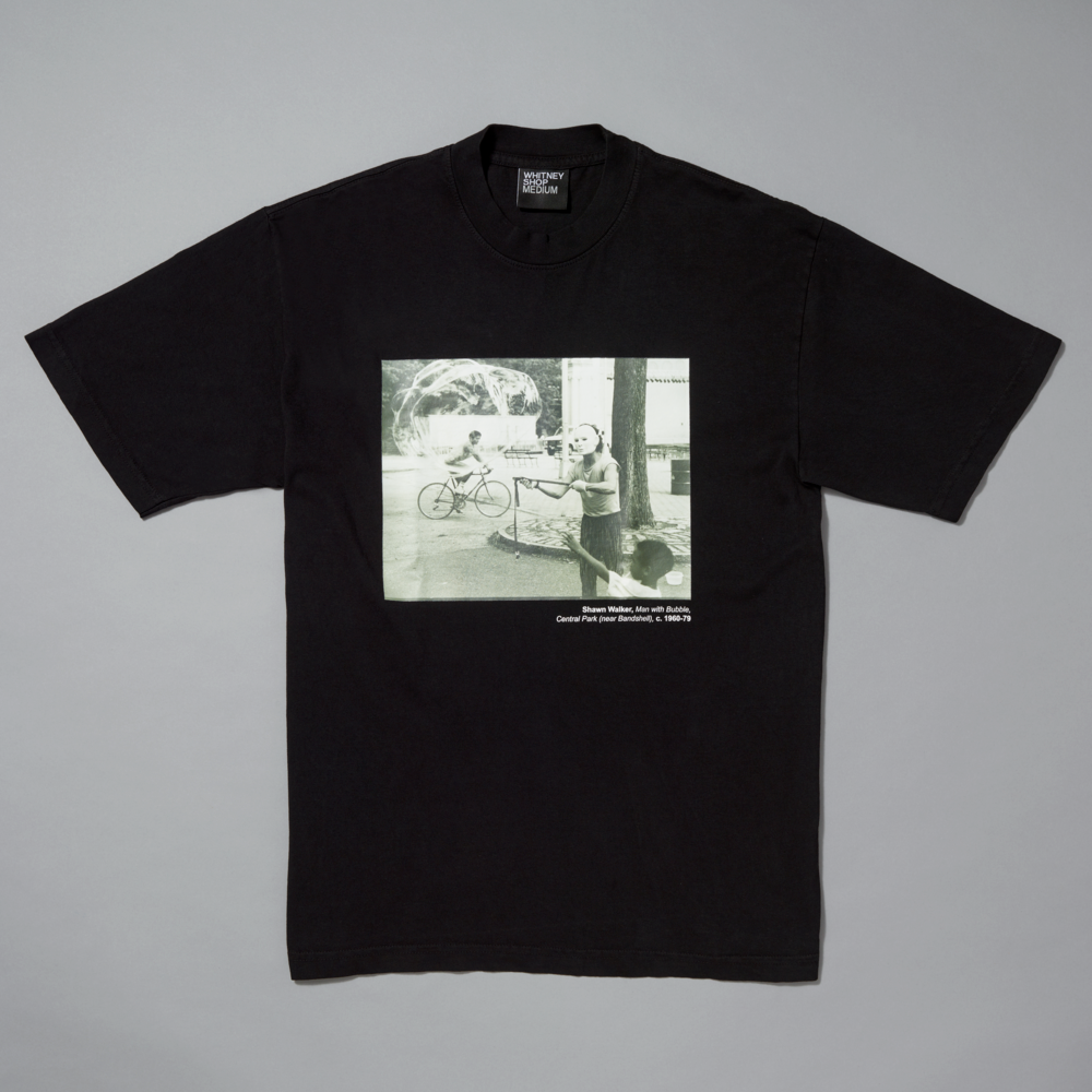 Black t-shirt with a graphic print on a gray background