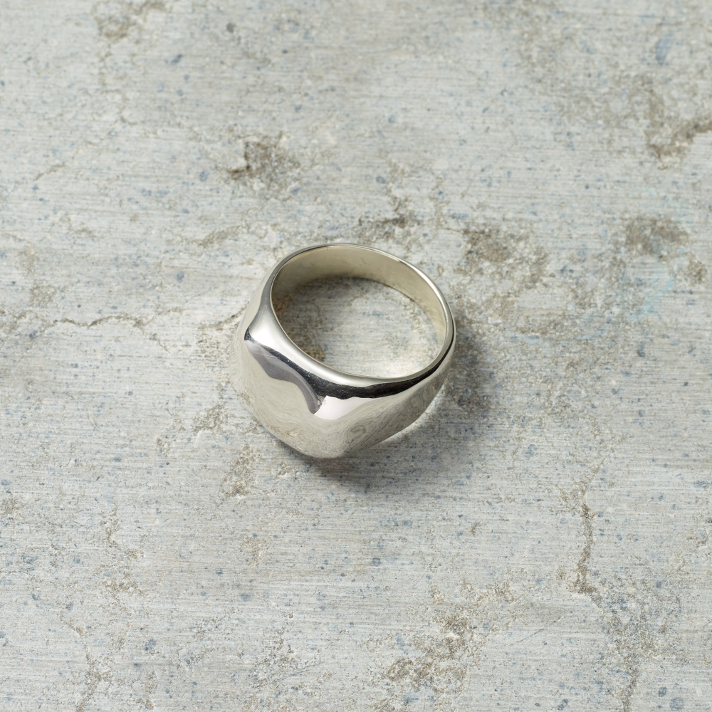 Silver ring on a textured gray surface