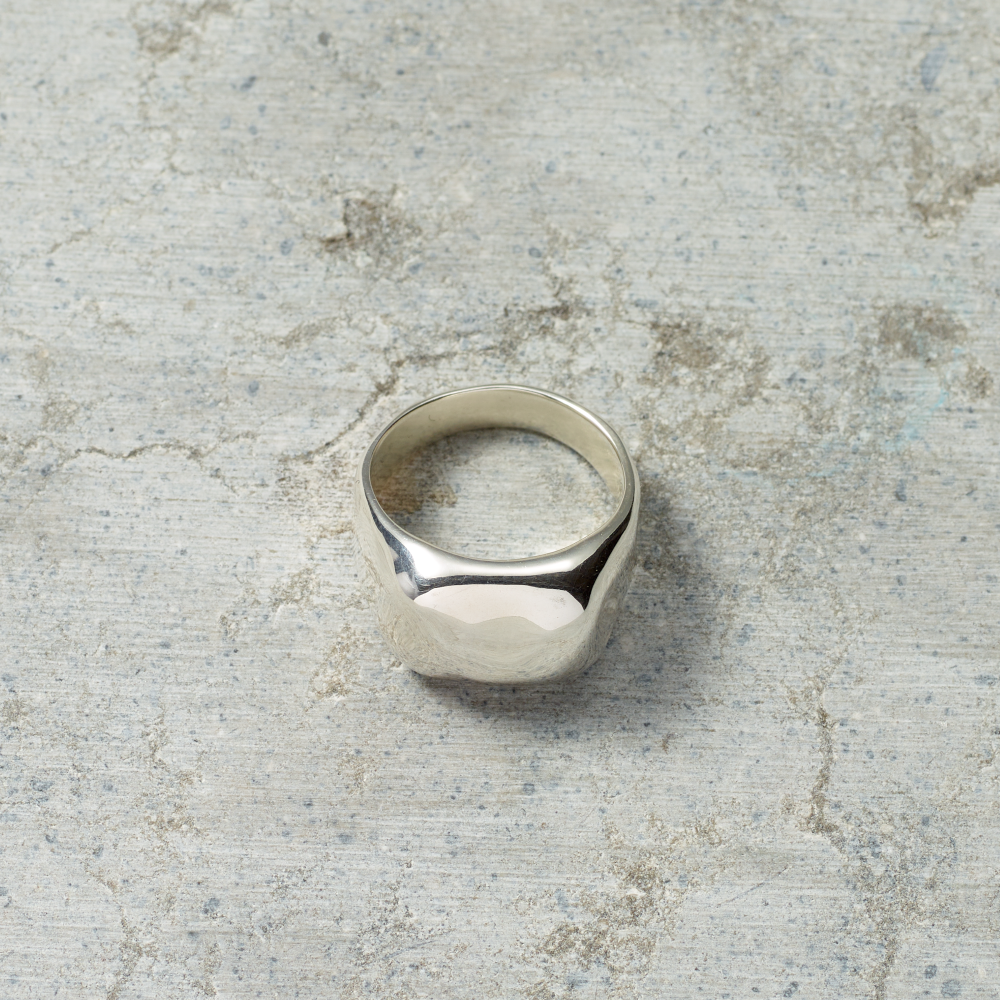 Silver ring on a textured gray surface