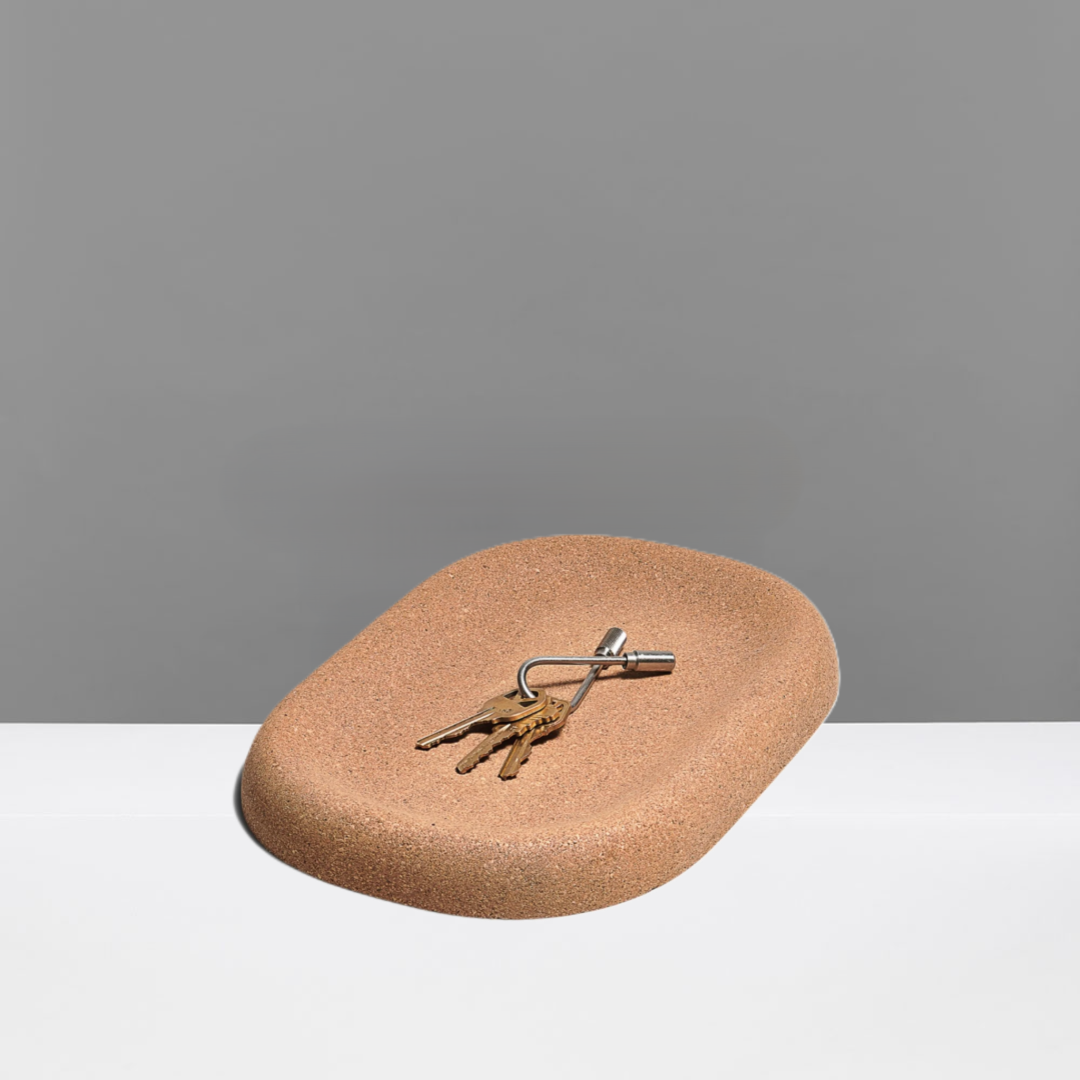 Cork tray with a set of keys on a gray background
