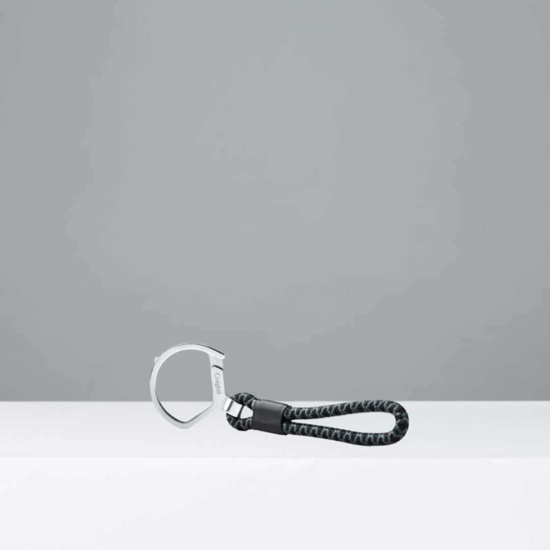 Keychain with braided gray cord on a gray background