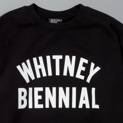 Black sweatshirt with 'WHITNEY BIENNIAL' white text on a gray background