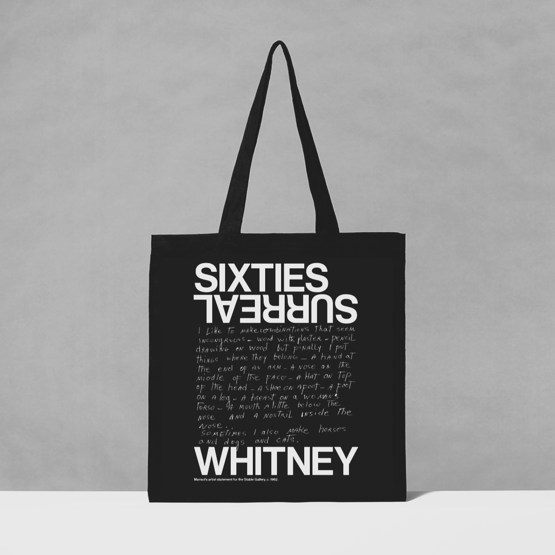 Black tote bag with white text on a gray background