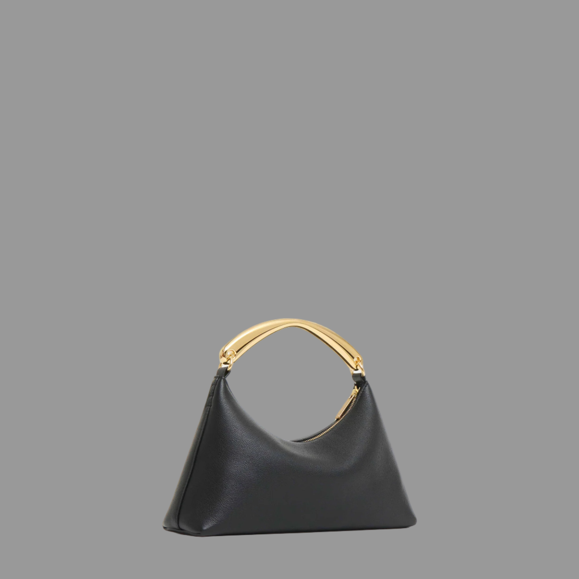 Black leather bag with gold handle on a grey background