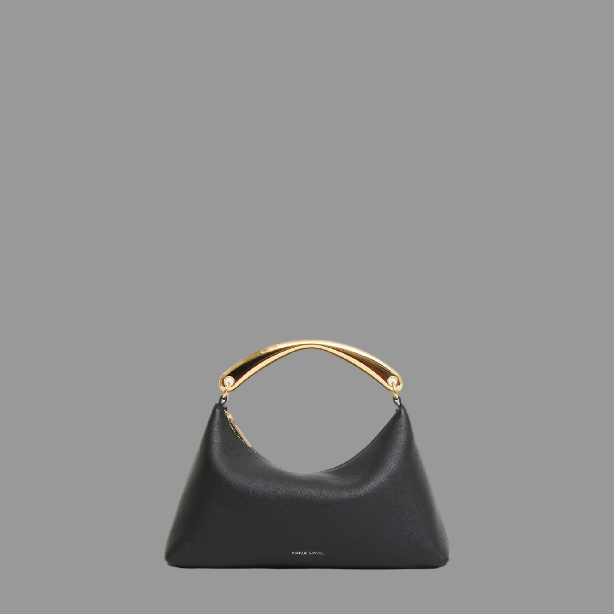 Black leather bag with gold handle on a grey background