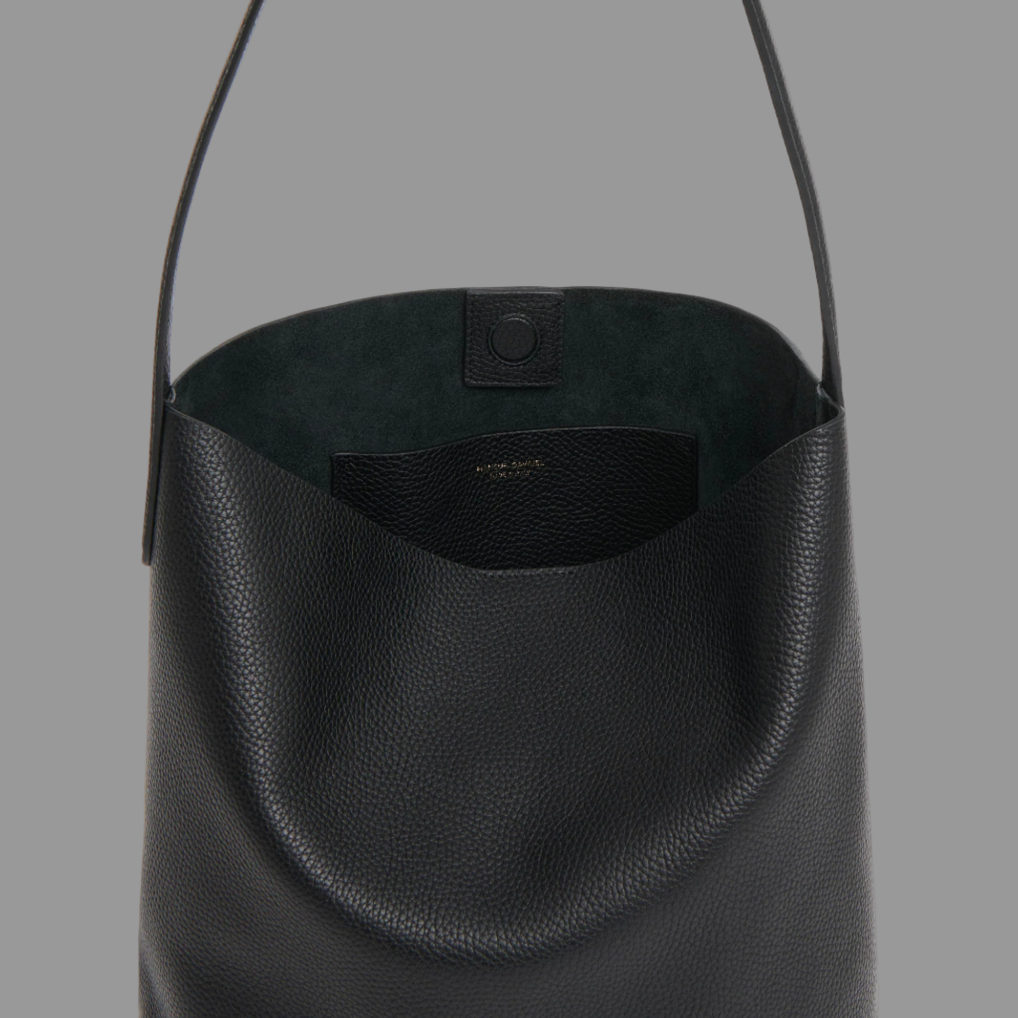 Black leather handbag on a light gray background