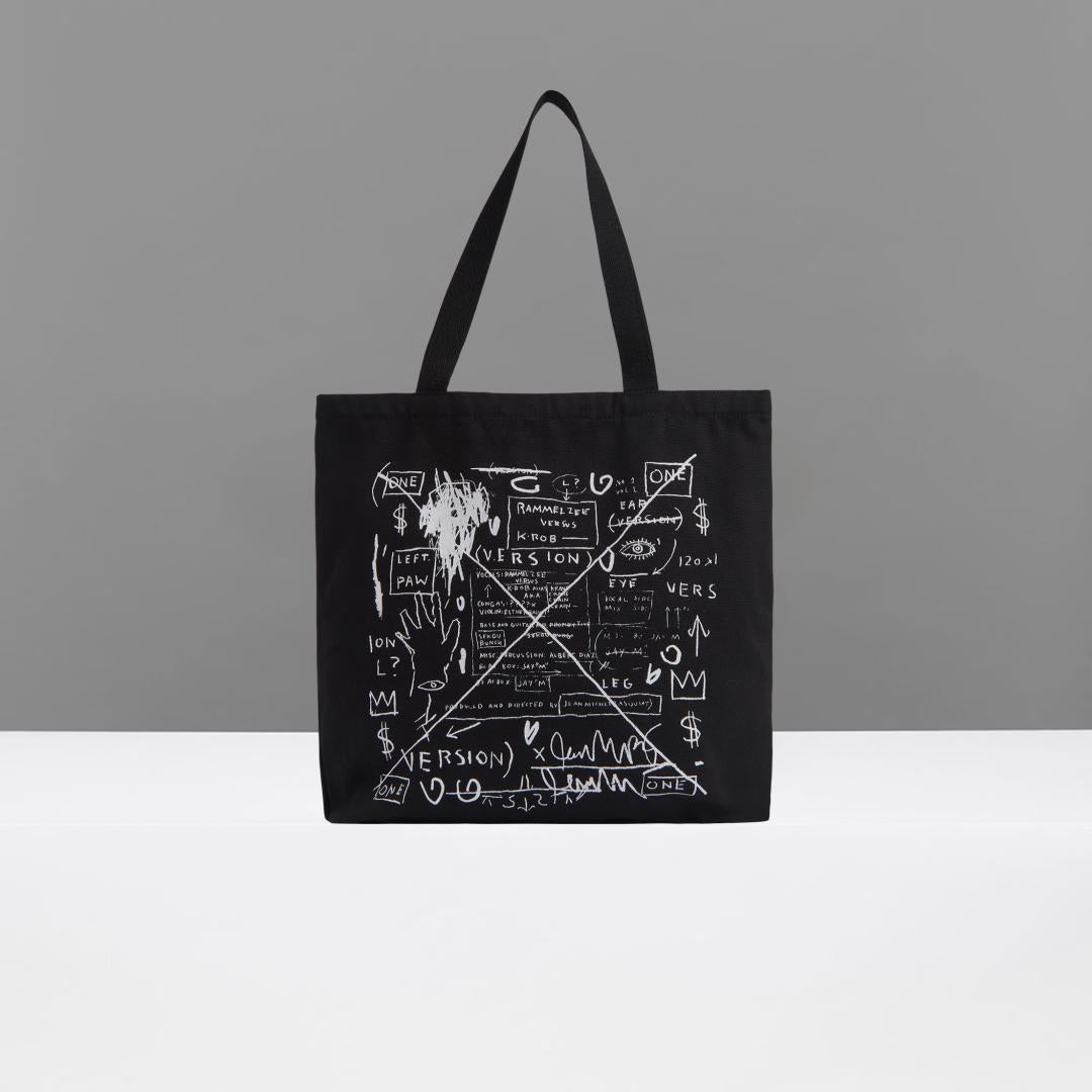 Black tote bag with white graphic design on a gray background