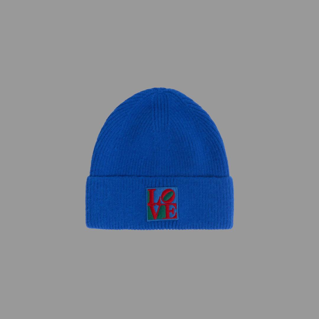 Blue beanie with Robert Indiana's 'LOVE' embroidery on a gray background