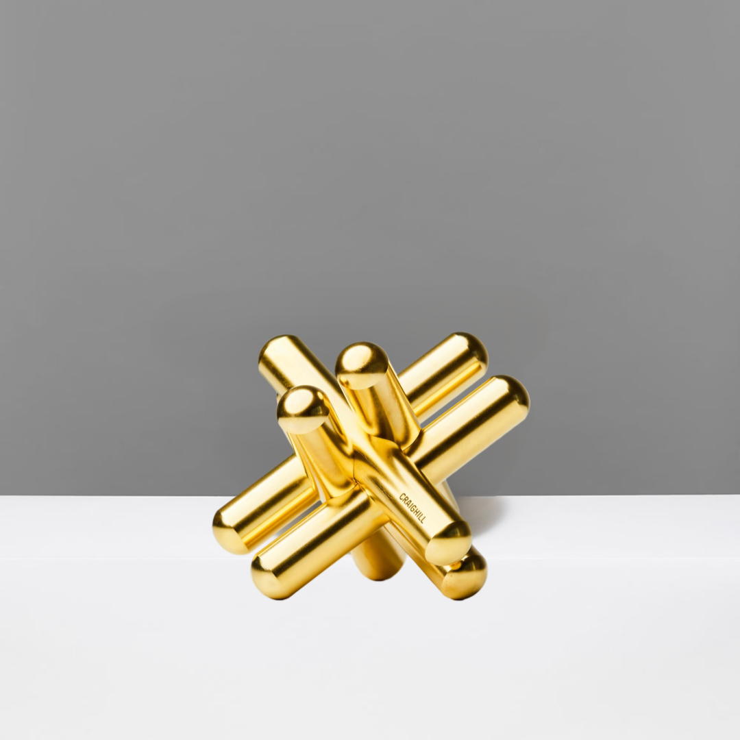 Gold abstract puzzle on a gray background