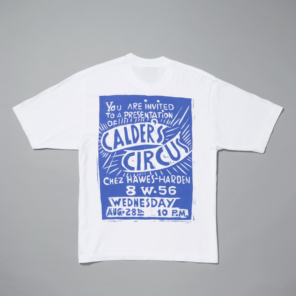 White t-shirt with blue graphic design on a gray background