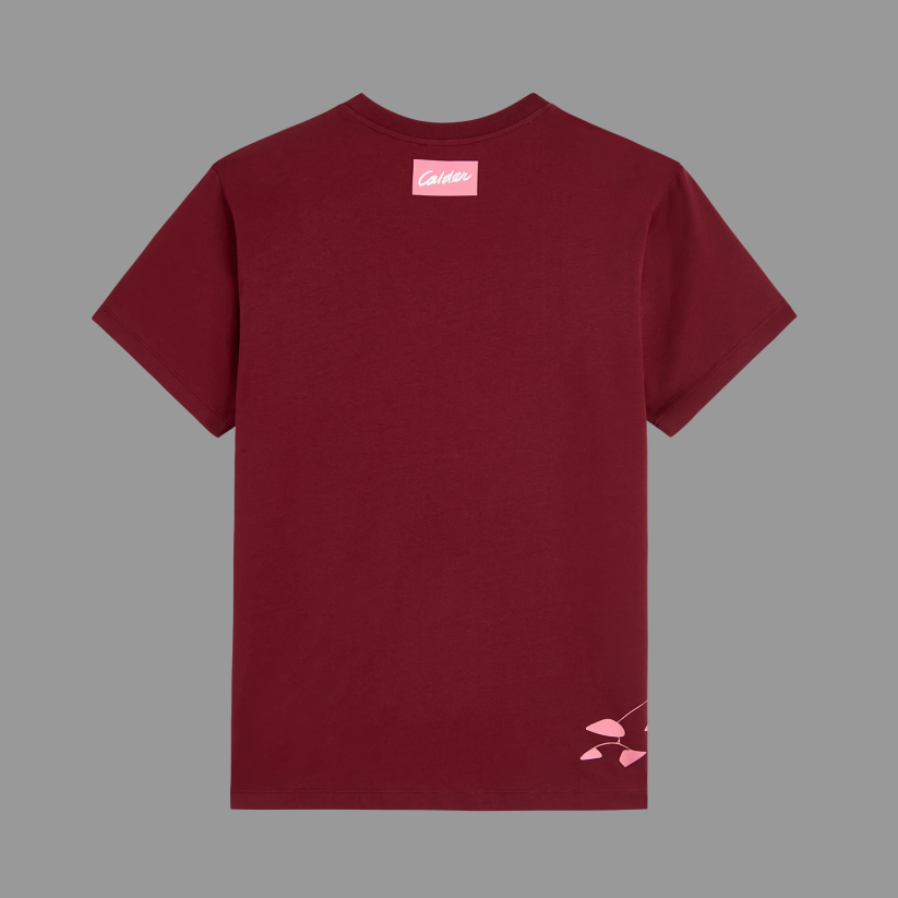 Maroon t-shirt with a small logo on the chest against a gray background