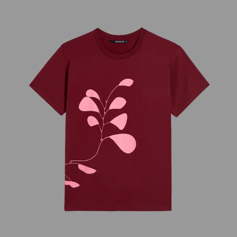 Maroon t-shirt with pink floral design on a gray background