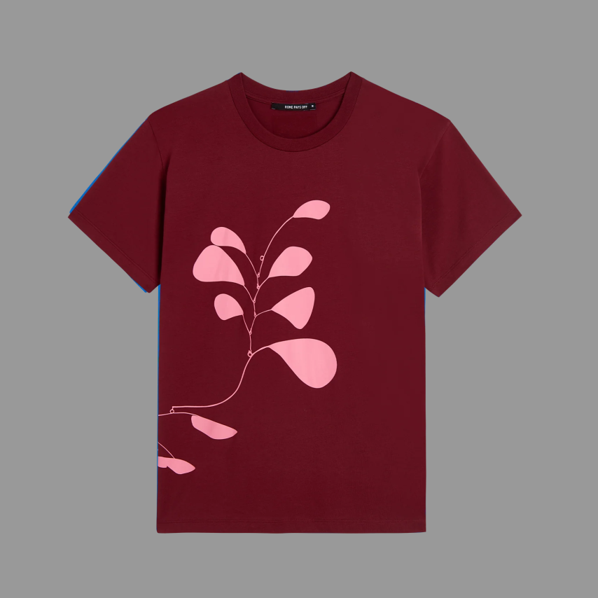 Maroon t-shirt with pink leaf design on a gray background