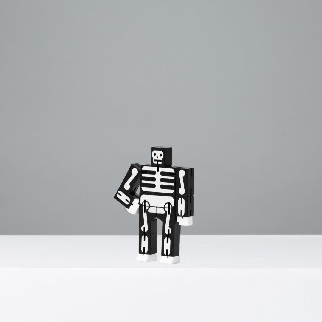 Black and white skeleton robot figure on a grey background