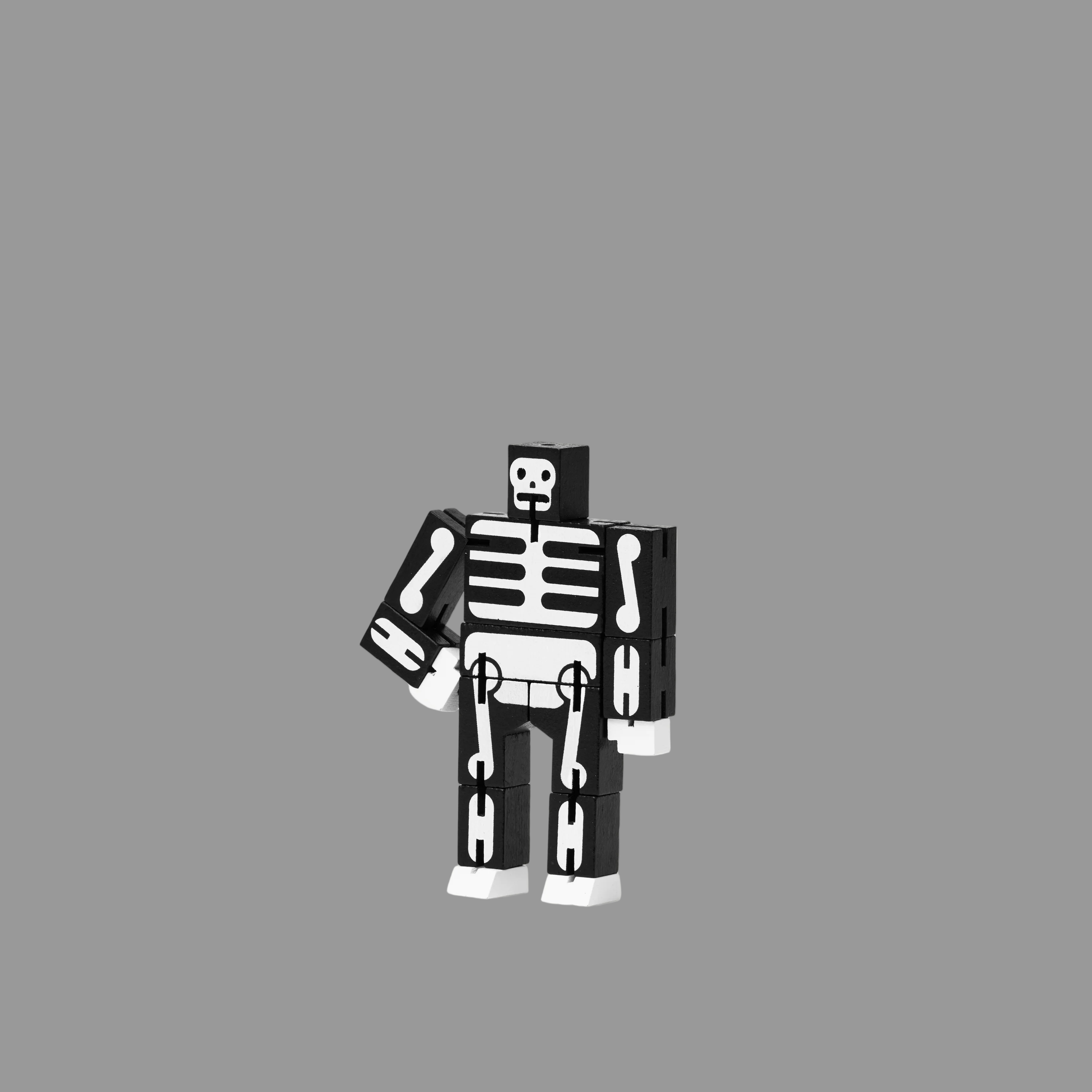 Black and white skeleton robot figure on a grey background