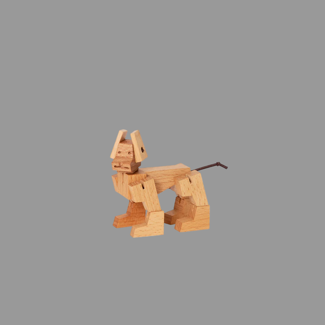 Wooden dog figurine on a grey background