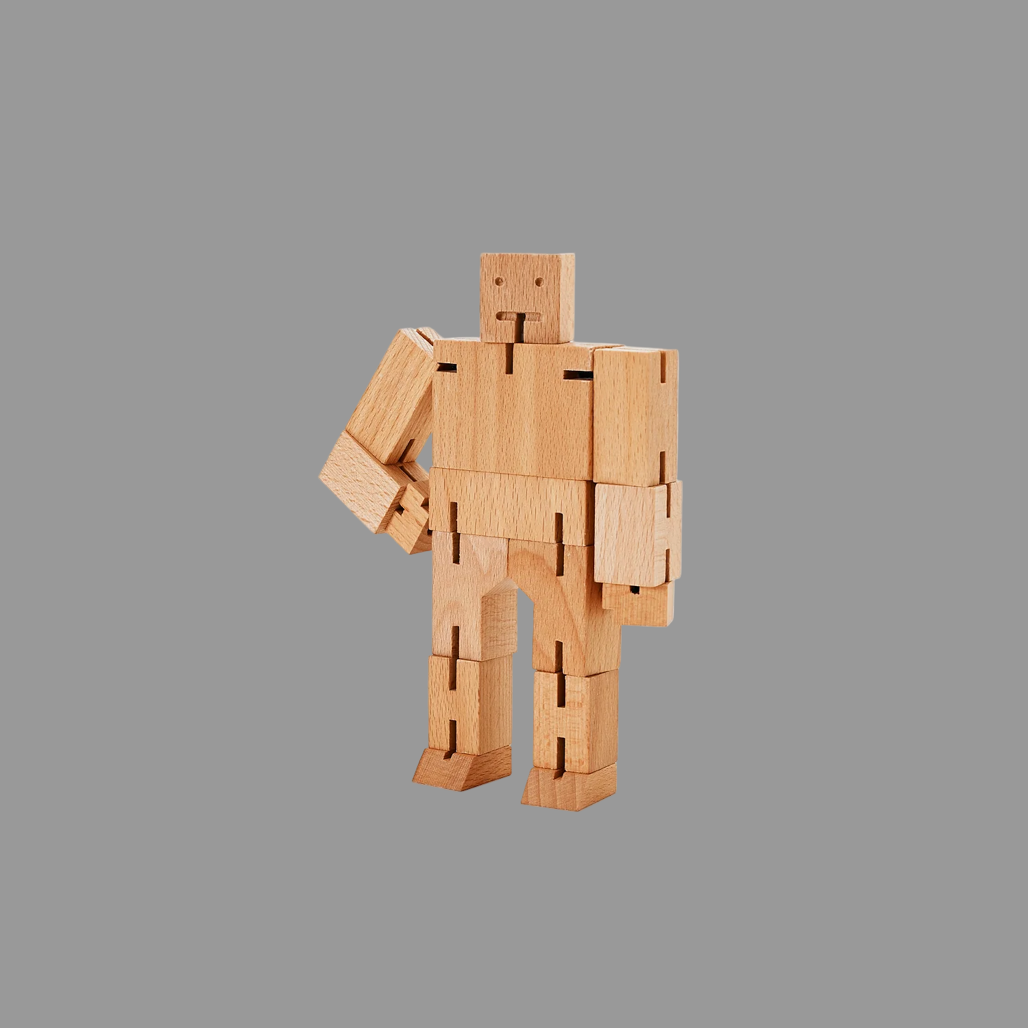 Wooden robot toy on a grey background