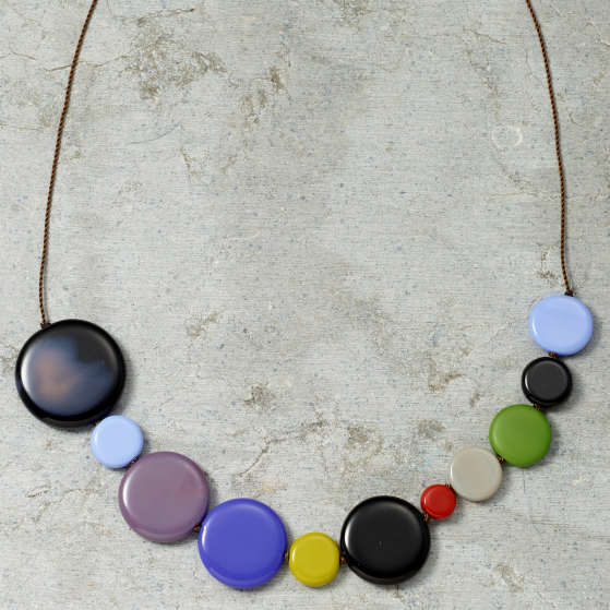 Necklace with colorful round beads on a textured surface