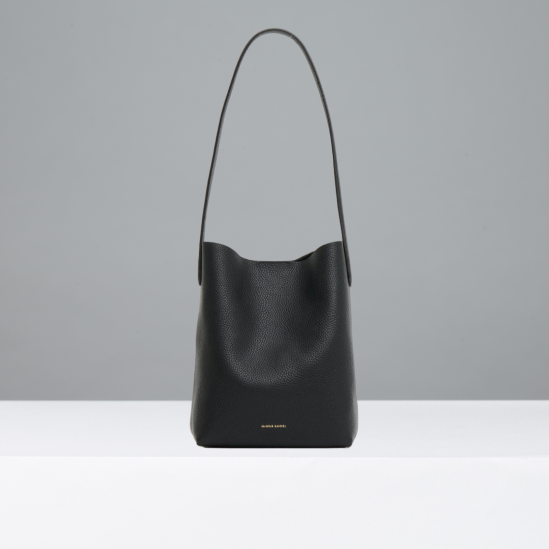 Black leather handbag on a light gray background