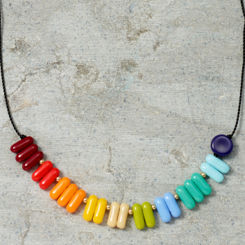 Colorful beaded necklace on a textured surface