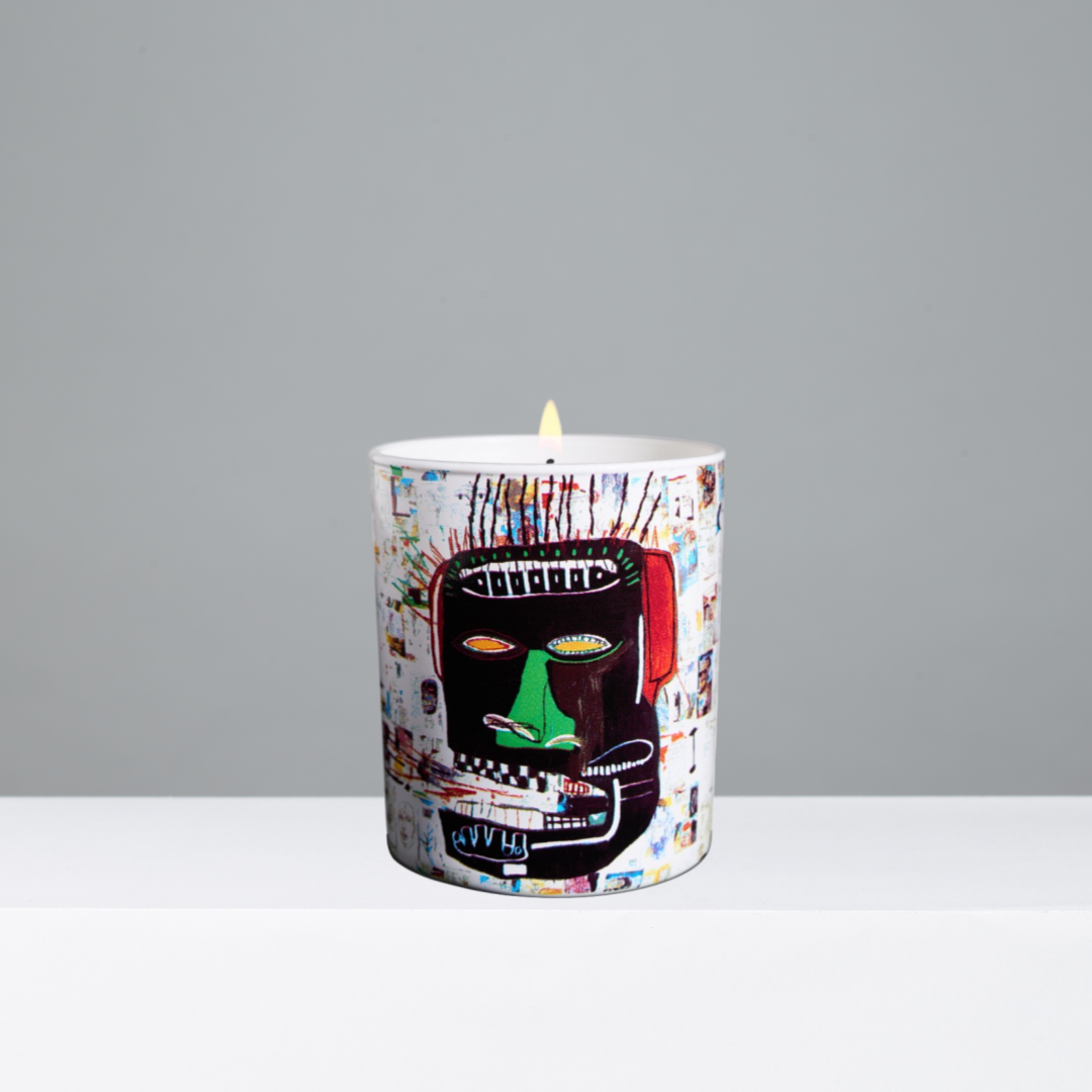 Candle with a colorful design on a gray background