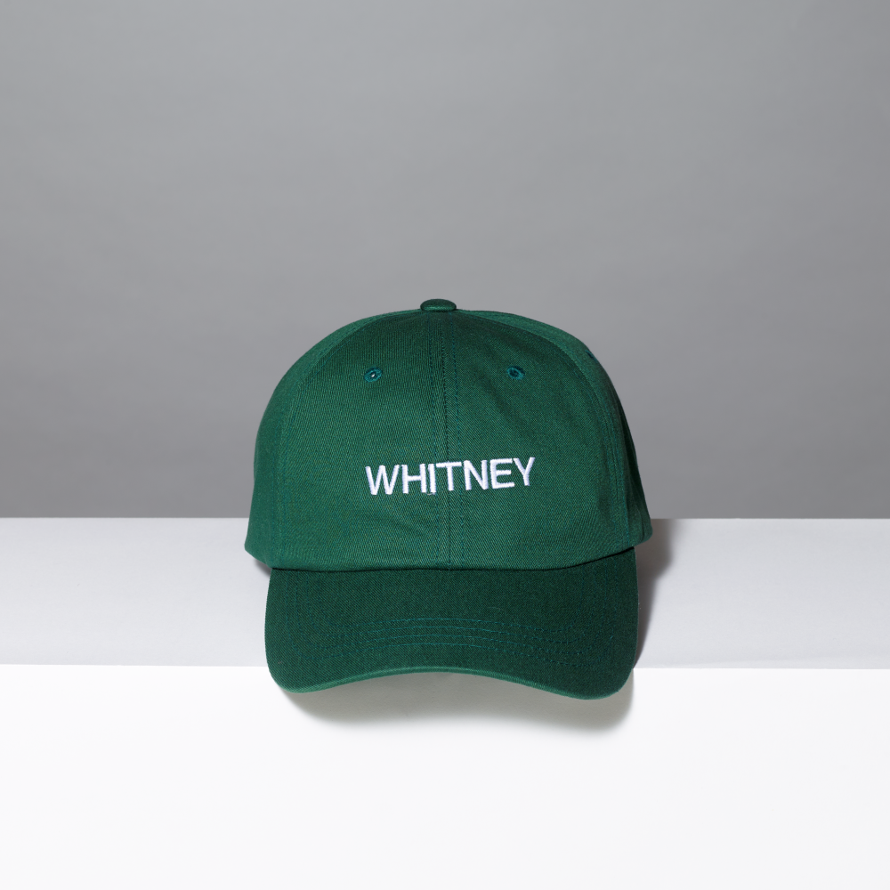 Green cap with 'WHITNEY' text on a gray and white background