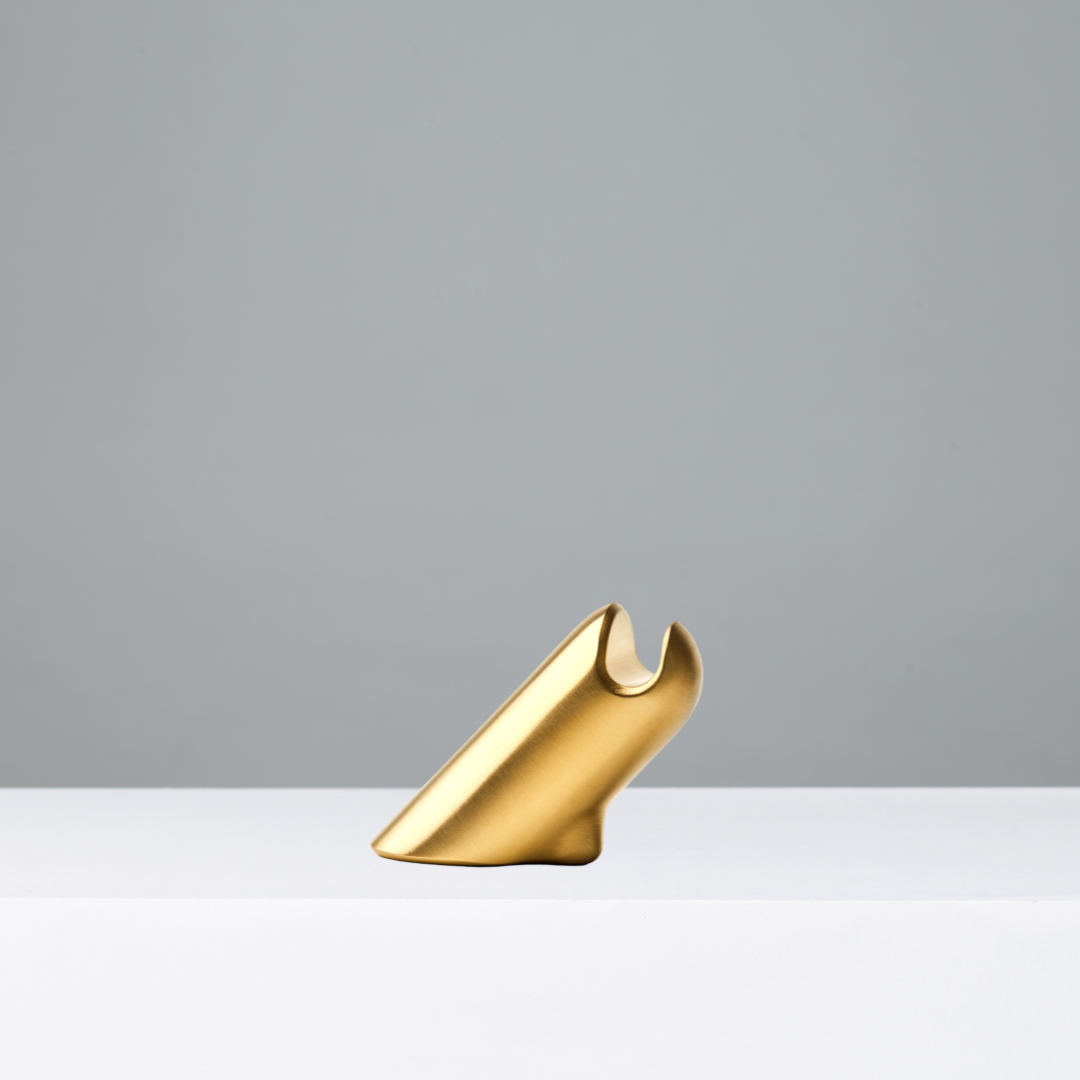 Brass eyewear stand on a gray background