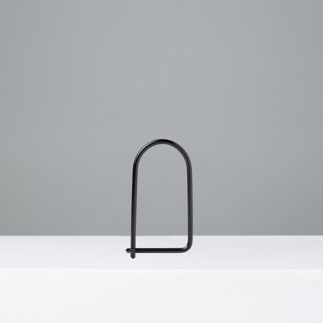 Black metal keyring on a gray background