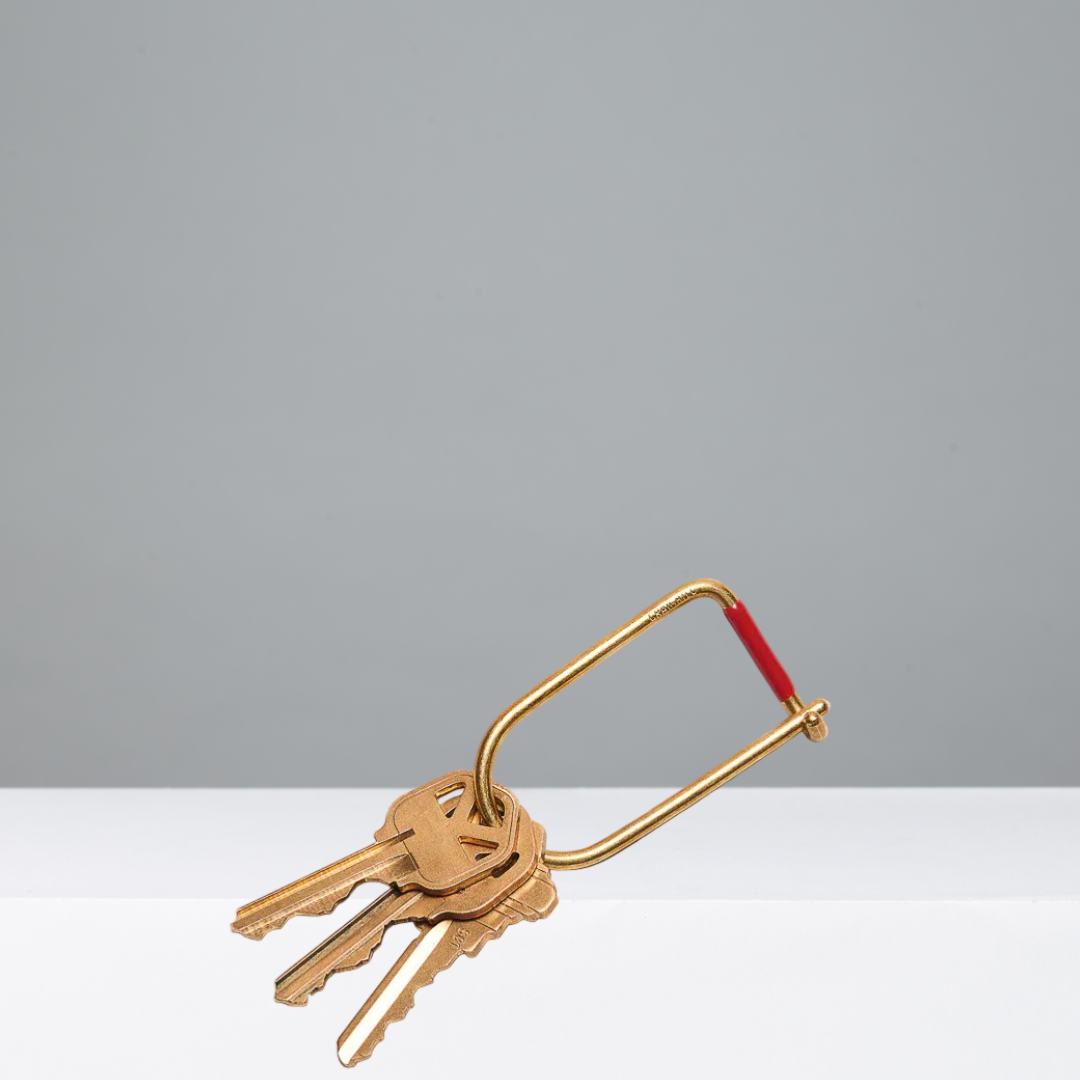 Gold keyring with keys on a gray background