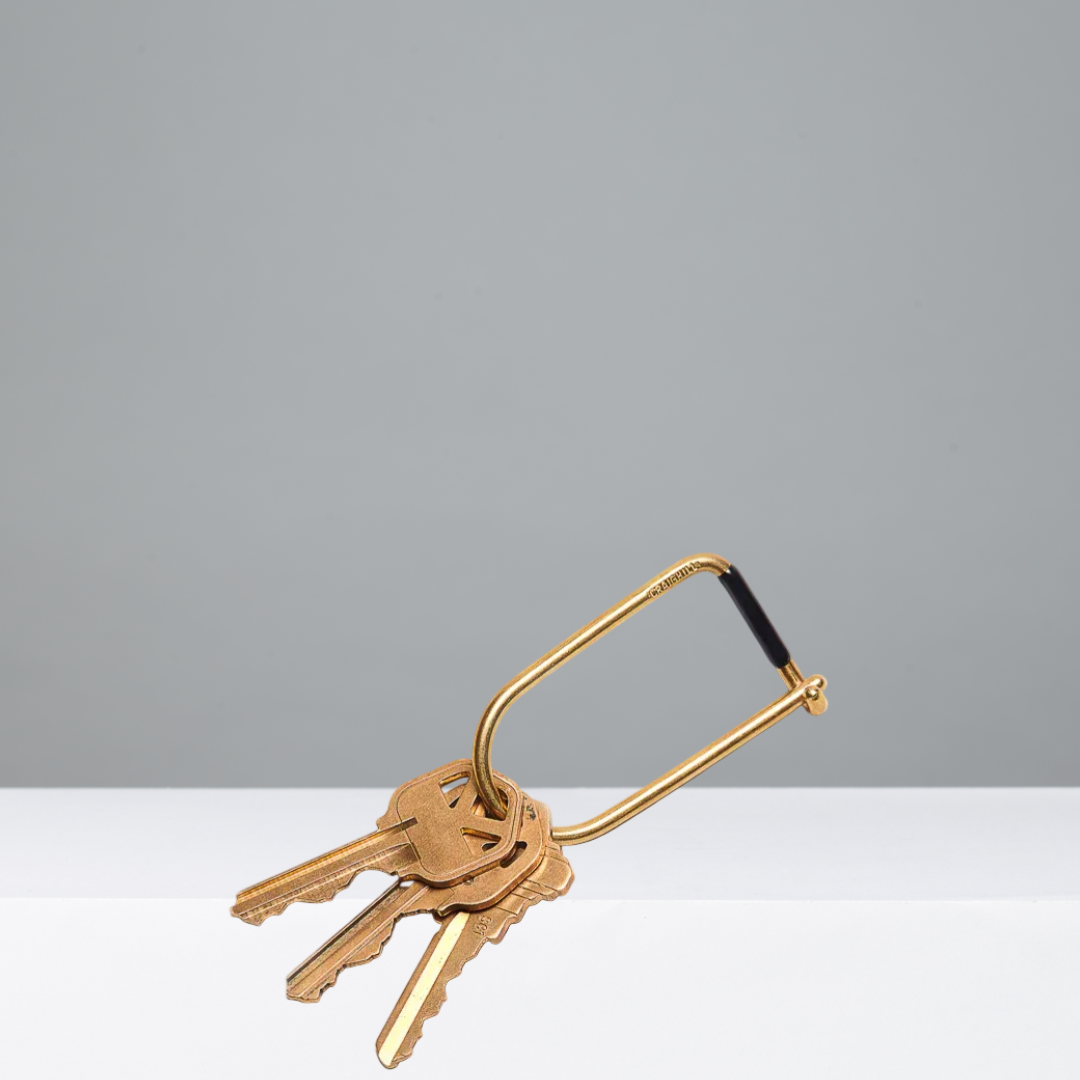 Gold keyring with keys on a gray background