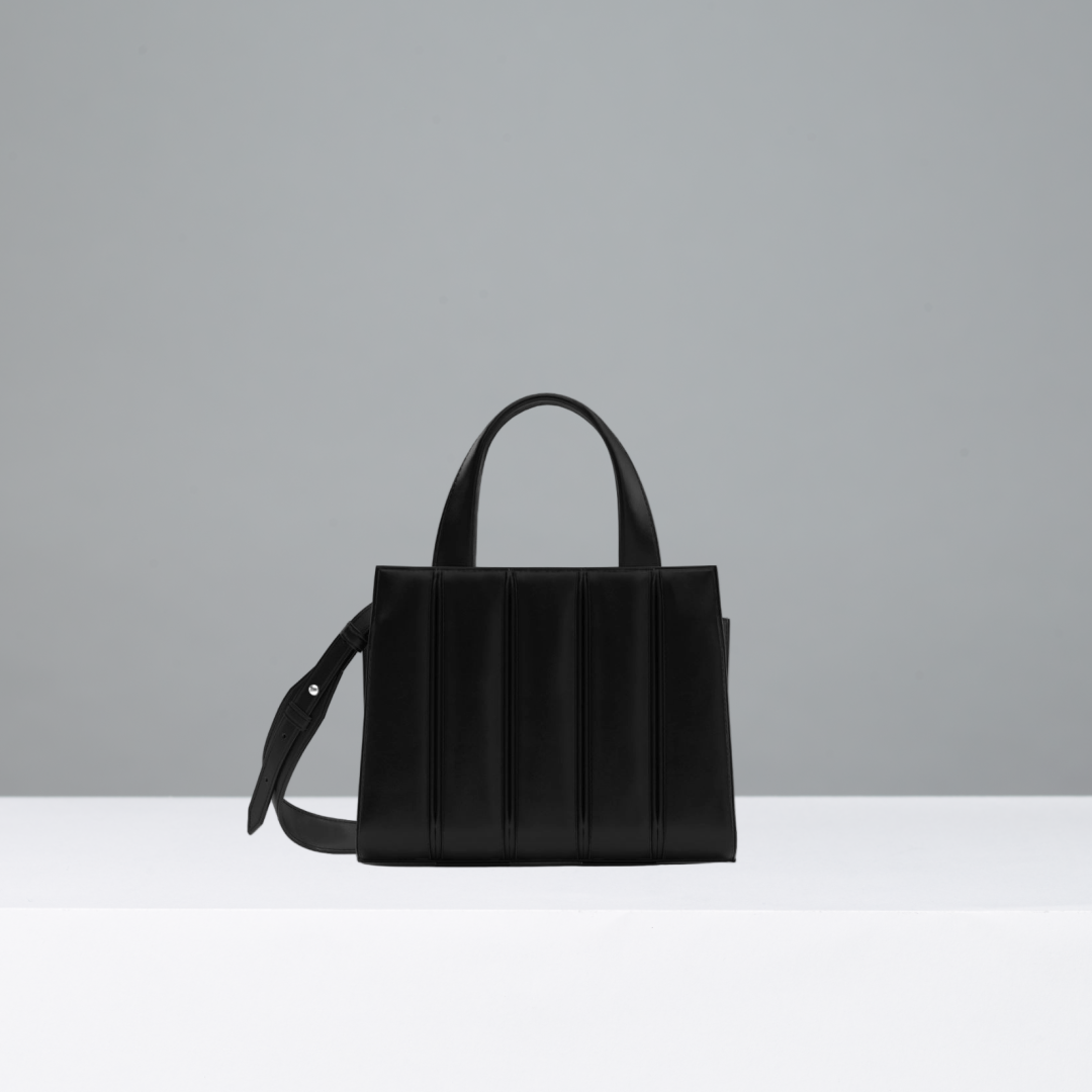 Black handbag on a gray background