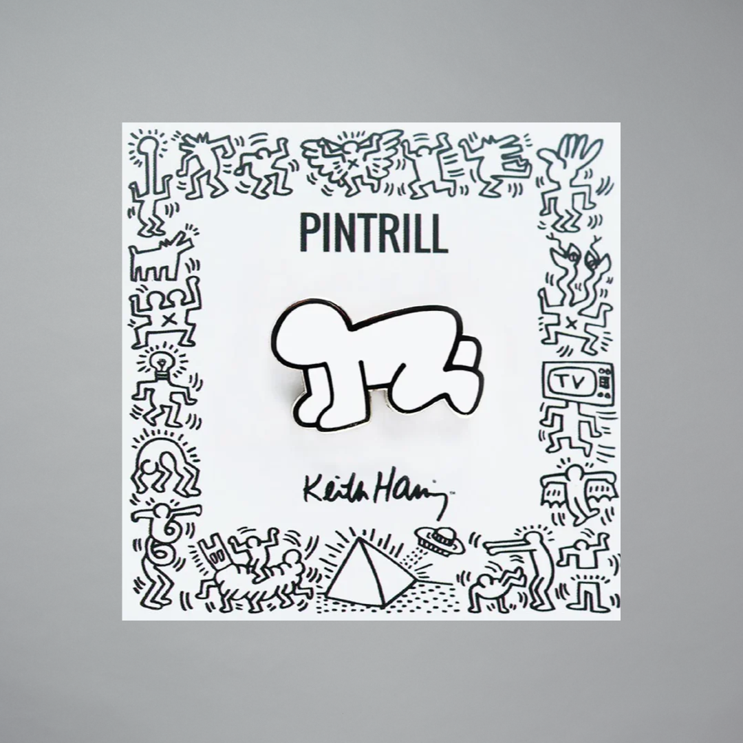 Keith Haring radiant baby pin in white on a gray background