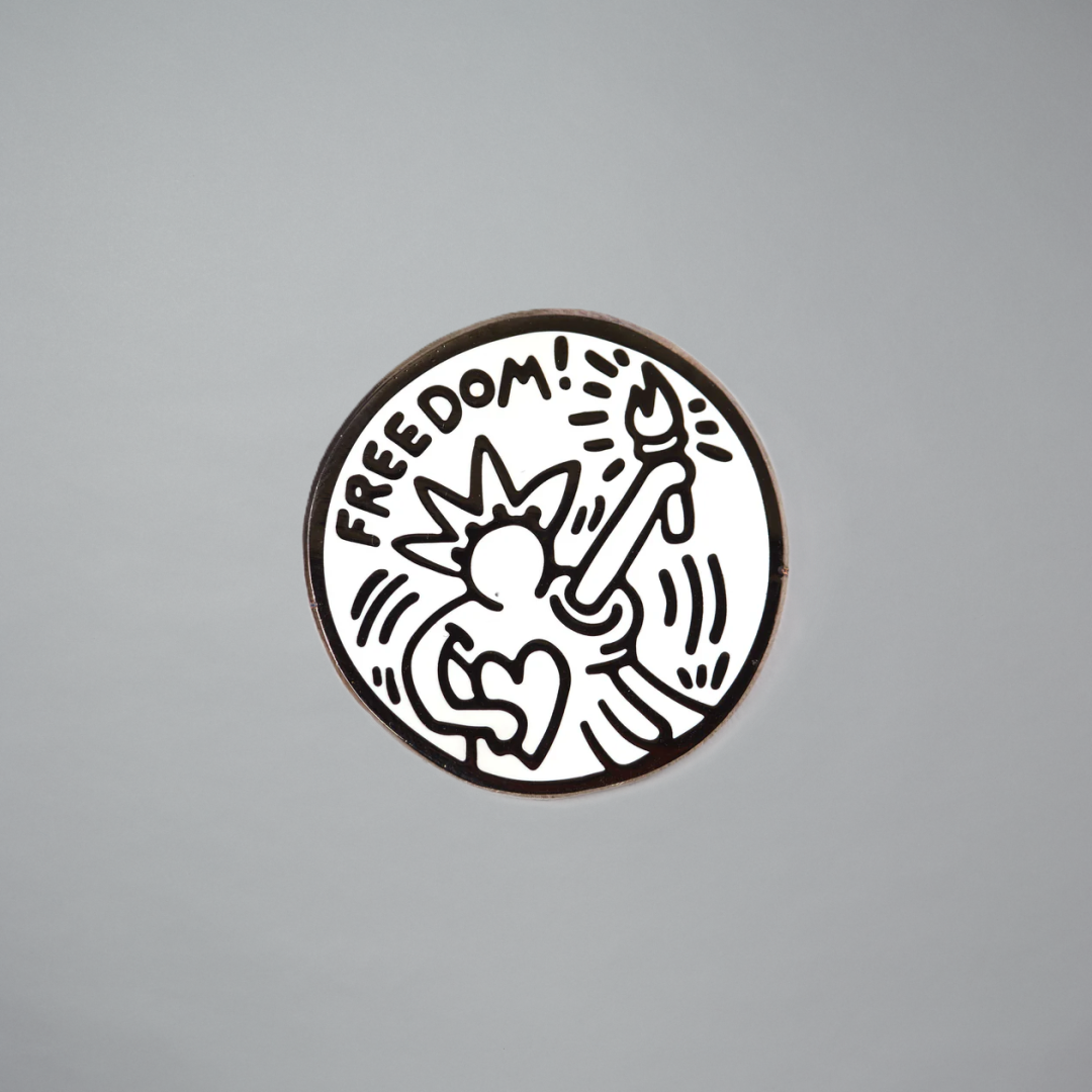 Keith Haring freedom pin on a gray background